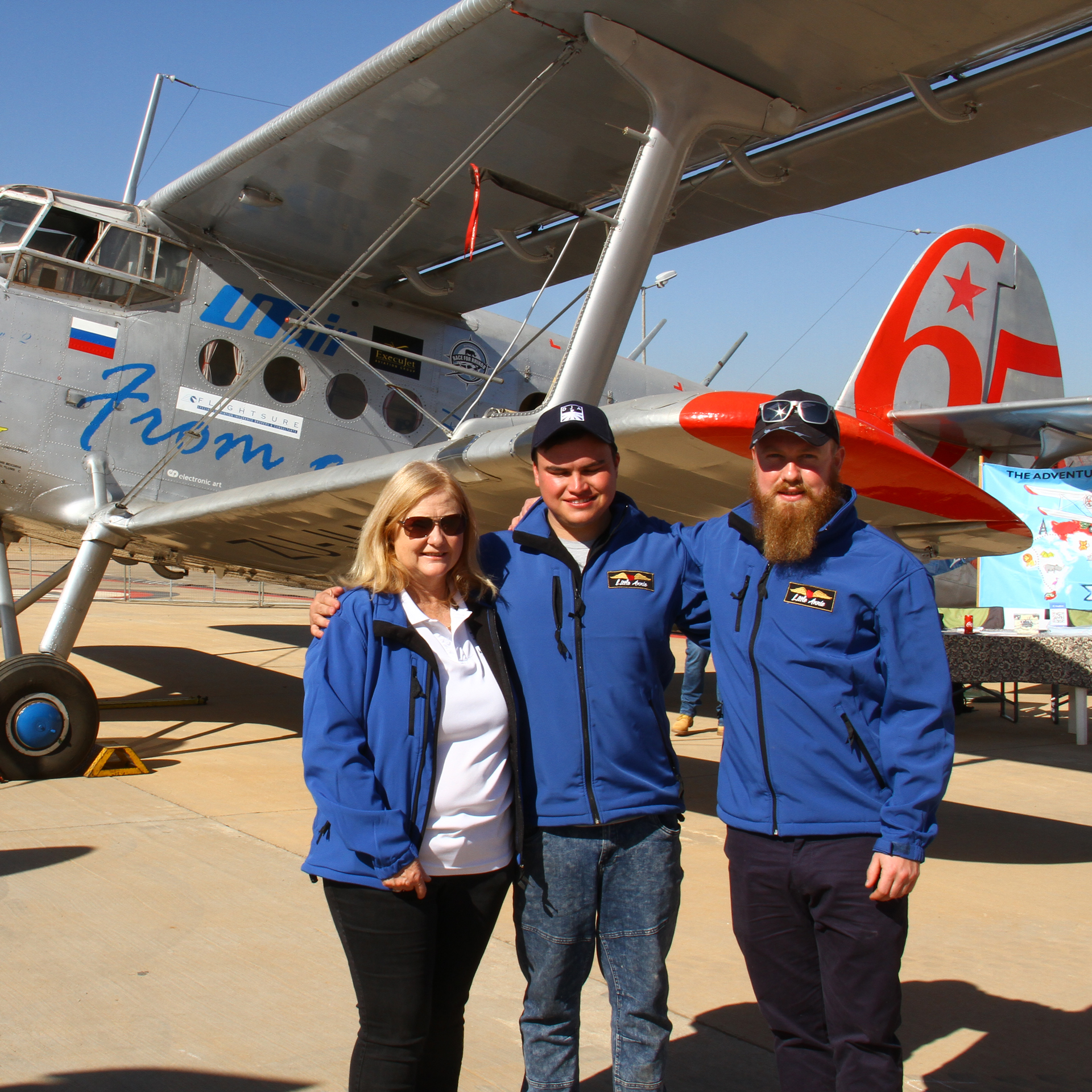 3 Persons in front of a plane
